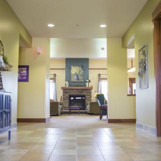 A well-lit lobby with a central fireplace and comfortable seating area.