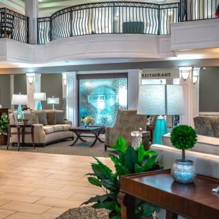 A spacious and elegantly designed hotel lobby featuring comfortable seating, stylish decor, and ambient lighting.