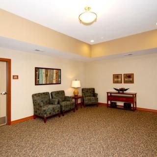 A waiting room with chairs and artwork on the walls.