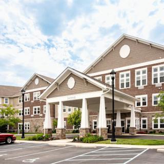 A modern residential building featuring a welcoming entrance and well-maintained surroundings.