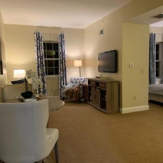 A cozy living room with comfortable seating, warm lighting, and a television.