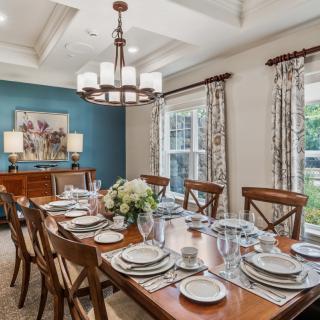 Elegant dining room with a beautifully set table and stylish chandelier.