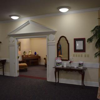 A traditional hallway with classic decor and furniture.