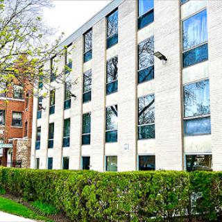 A modern apartment building surrounded by greenery.