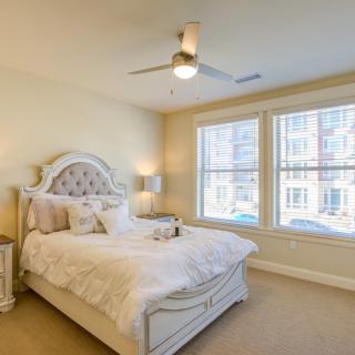 A cozy and well-lit bedroom with elegant decor.
