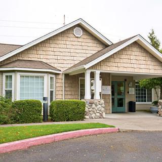A residential building with a well-maintained entrance and landscaping.