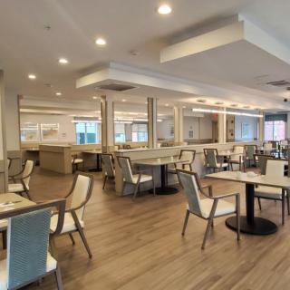 A modern and spacious restaurant dining area with chairs and tables arranged neatly.