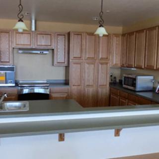 A modern kitchen with wooden cabinets and a clean countertop.