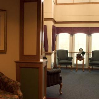 A cozy waiting area with seating and large windows.