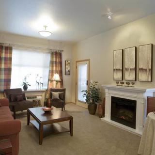 A cozy living room featuring a fireplace, comfortable seating, and tasteful decor.