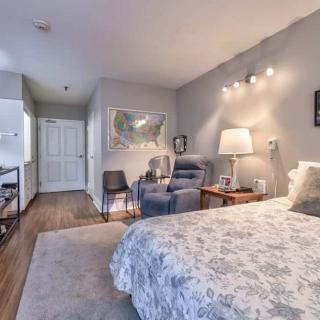 A modern and cozy bedroom with elegant furnishings and soft lighting.
