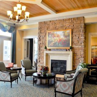 A cozy living room with a brick fireplace and comfortable seating arrangement.