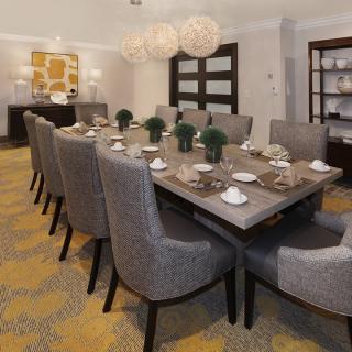 A modern and elegant dining room with a stylish table set for a meal.