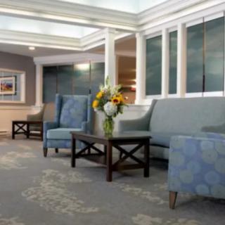 A modern lobby area with comfortable seating and floral decor.