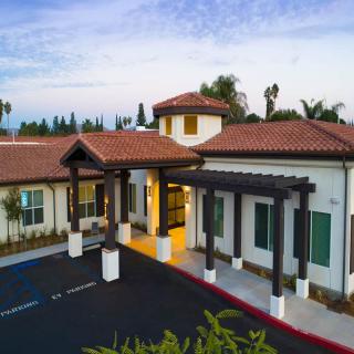 A modern residential building with a welcoming entrance and tiled roof.