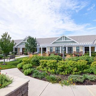 A well-maintained residential building with beautiful landscaped gardens and pathways.