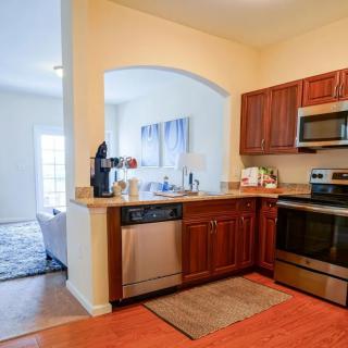 A modern kitchen with stainless steel appliances and wood cabinets.