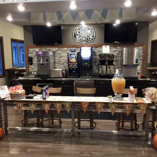 A cozy coffee shop setup with a welcoming counter and decorated invite table.