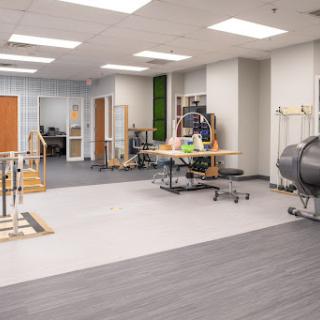 A spacious and modern physical therapy room equipped with various rehabilitation tools.