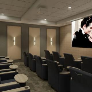 A cozy home theater with comfortable seating and a large screen.