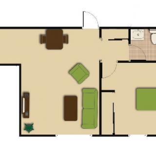 A floor plan of a small apartment, featuring a living room with furniture, a bedroom, and a bathroom.