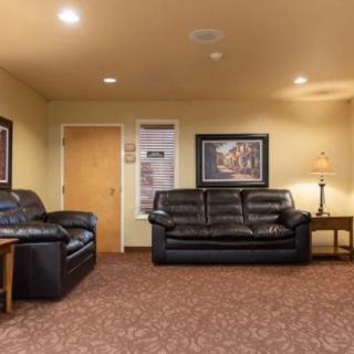 A cozy living room with comfortable sofas and warm lighting.