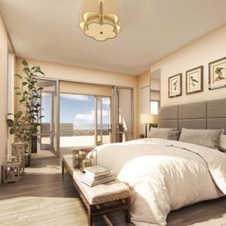 A luxurious and modern bedroom with large windows and a stunning balcony view.