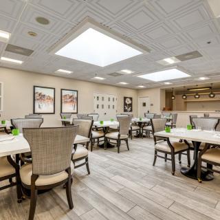 A spacious and modern dining area with elegant furniture and contemporary decor.