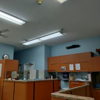 A view of an office interior featuring wooden cabinets and overhead lighting.