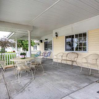 A cozy covered porch with seating and a table, perfect for outdoor relaxation.