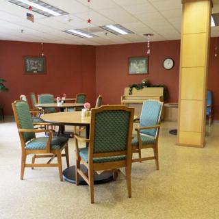 A community dining area with tables and chairs arranged for seating.