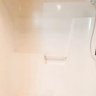 A clean and minimalist shower area in a bathroom.
