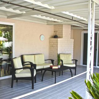 A cozy patio with outdoor seating under a covered porch.