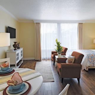 A cozy living room and dining area in a modern apartment with stylish decor.
