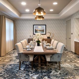 Elegant dining room with a modern chandelier and sophisticated table setting.
