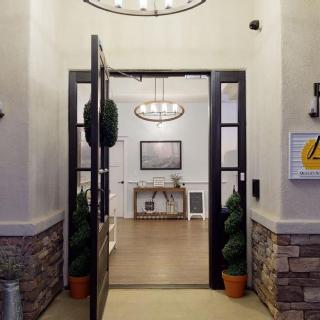 A welcoming entrance to a stylish lobby with elegant lighting and potted plants.