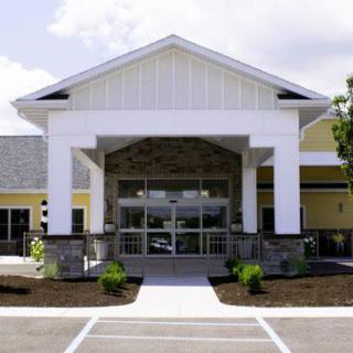 A modern building entrance with landscaped surroundings.