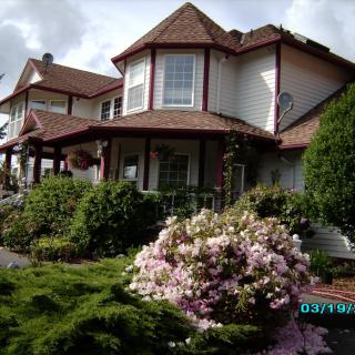 A beautiful residential house surrounded by a lush garden.