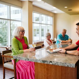 A warm and engaging atmosphere in a caf where seniors enjoy conversation and drinks.