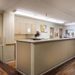 A hospital reception area with a front desk and medical equipment.