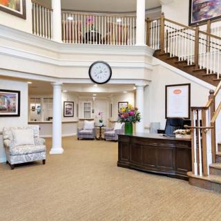 A welcoming lobby area with a reception desk, comfortable seating, and a staircase.