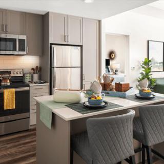 A modern kitchen with stainless steel appliances and a stylish island counter.