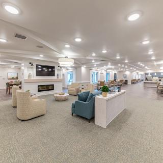 A spacious and modern lounge area with comfortable seating and ample lighting.