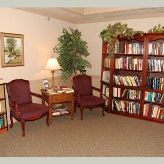 A cozy reading corner with bookshelves and comfortable seating.