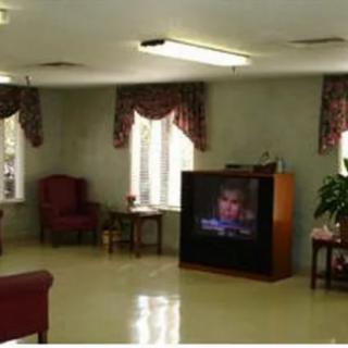 A cozy living room with a vintage television and comfortable seating.