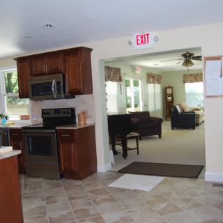 A modern open floor plan featuring a kitchen and adjoining living area.