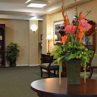 A well-decorated lobby area with a floral arrangement on a central table.