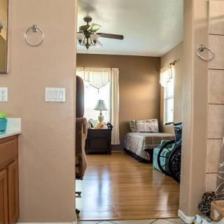 A cozy indoor space featuring a living room with hardwood floors and daylight streaming in through the windows.