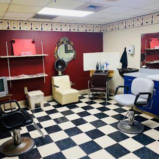 A cozy barbershop interior featuring a checkerboard floor and stylish seating.