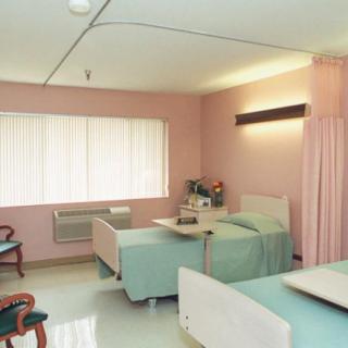 A clean and well-organized hospital room with neatly arranged beds.